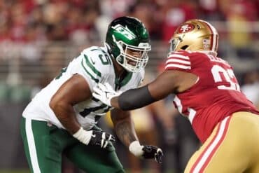 Alijah Vera-Tucker blocks a defender.