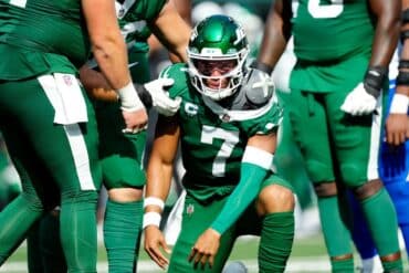 Justin Fields on his knees in the huddle.
