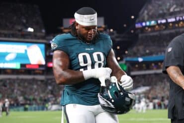 Philadelphia Eagles defensive tackle Jalen Carter holds his helmet.