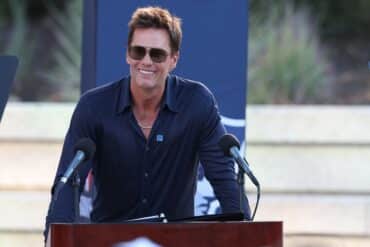 Tom Brady stands at a podium.