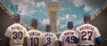 Expos players with their backs turned to camera.