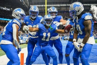 Detroit Lions players stands in the end zone.