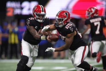 Falcons quarterback Michael Penix Jr. hands the ball off.