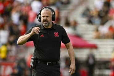 Nebraska Cornhuskers head coach Matt Rhule fixes his mic.