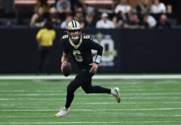 New Orleans Saints quarterback Tyler Shough holds the ball and runs.