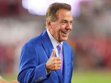 Nick Saban sticks his thumb up.