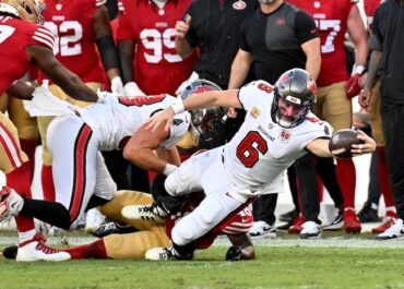 Baker Mayfield dives for a ball.