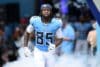 Tennessee Titans tight end Chig Okonkwo runs out of the tunnell.