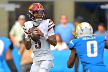 Jayden Daniels holds the ball.