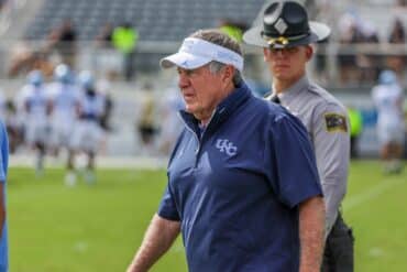 Bill Belichcik walks on the field.