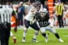 Defensive end Maxx Crosby gets low on a play.