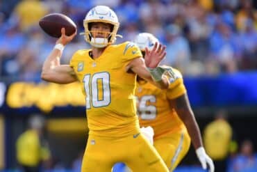 Justin Herbert readies to throw the ball.