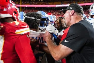 Dan Campbell pulls someone back.