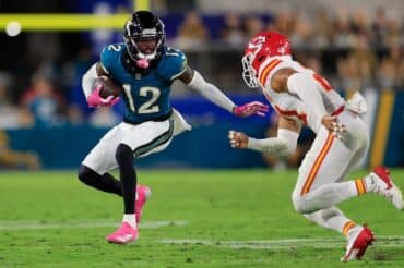Travis Hunter runs the ball.