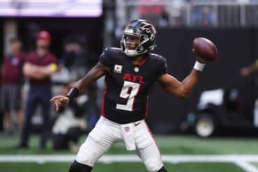 Michael Penix throws a ball.