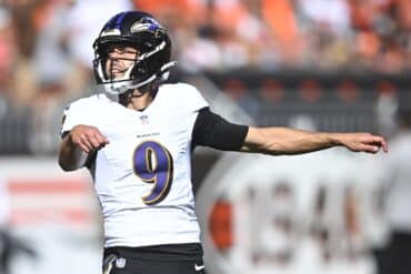 Justin Tucker sets up to kick.