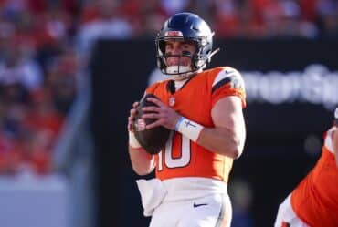Bo Nix holds the ball.