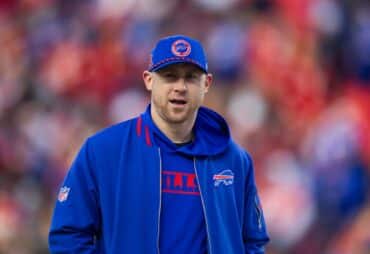 Joe Brady stands and stares.