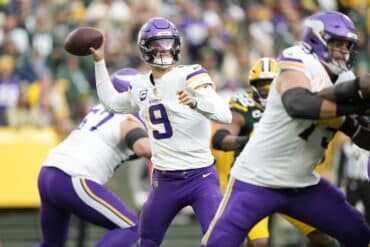 J.J. McCarthy throws the ball for the Vikings.
