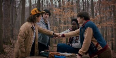 The boys of Stranger Things put their hands in the middle.