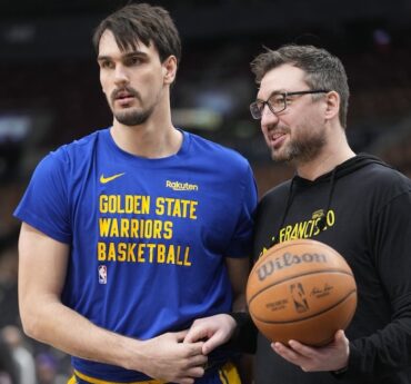 Chris DeMarco holds a basketball.