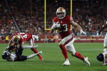 Christian McCaffrey runs with the ball.