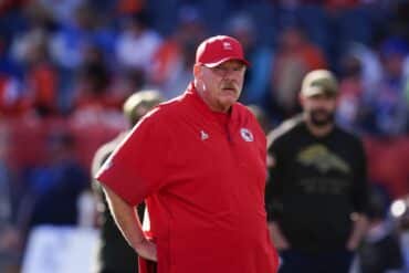 Chiefs head coach Andy Reid stand with hands on hip.