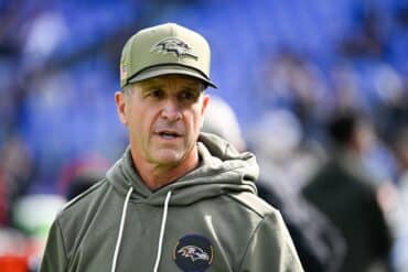 Ravens coach John Harbaugh stands and stares.