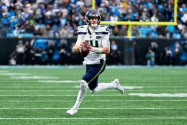 Sam Darnold holds ball.
