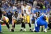 Aaron Rodgers stands at the line of scrimmage.
