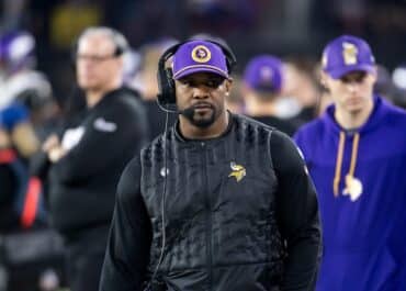 Vikings defensive coordinator Brian Flores stands on the sidelines.