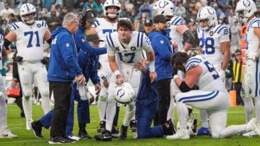 quarterback Daniel Jones gets helped off of the field.