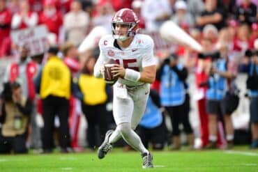 Ty Simpson throws with the ball.