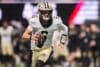 Saints quarterback Tyler Shough runs with the ball.