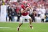 Hoosiers quarterback Fernando Mendoza runs the ball.