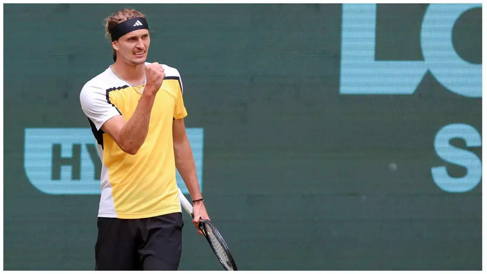 Alexander Zverev celebrating a point during a clay court tennis match.