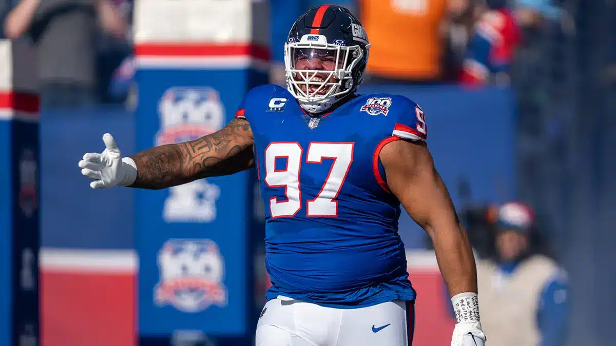 Dexter Lawrence in blue New York Giants uniform celebrating during a game.