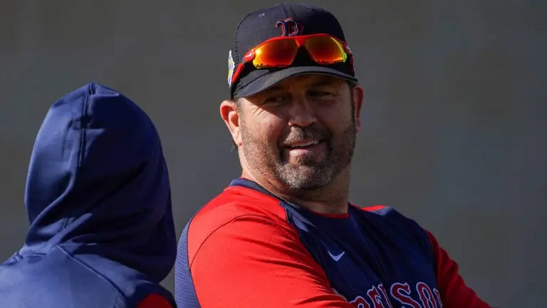 Jason Varitek wearing a Red Sox uniform, smiling during a practice session.