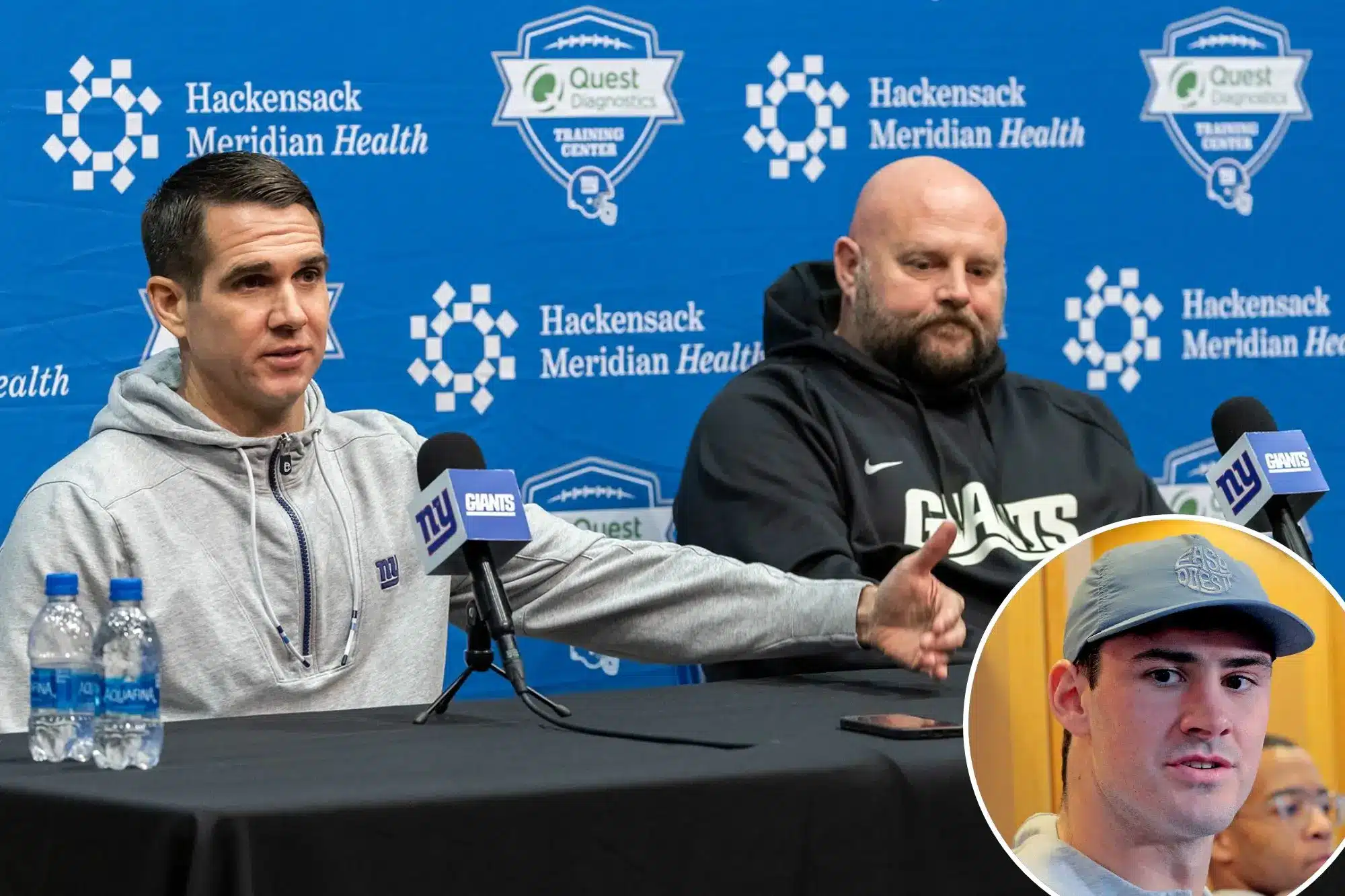 Joe Schoen at a press conference with teammates and Giants branding in the background.