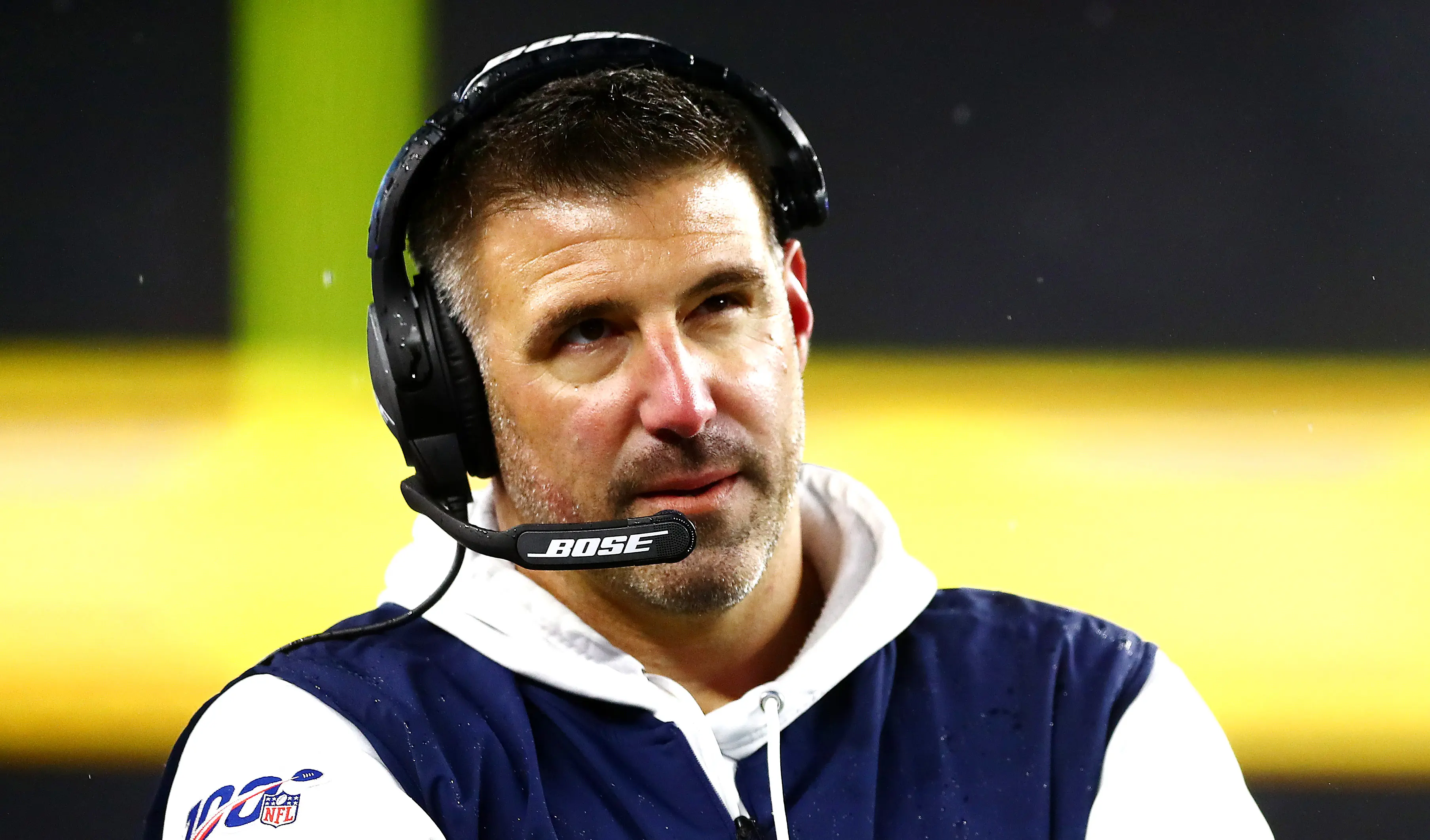 Mike Vrabel, NFL coach, wearing a headset and looking attentive during a game.