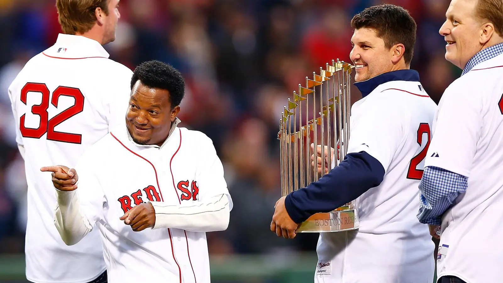 Pedro Martinez and Kevin Youkilis celebrate with the Red Sox World Series trophy.