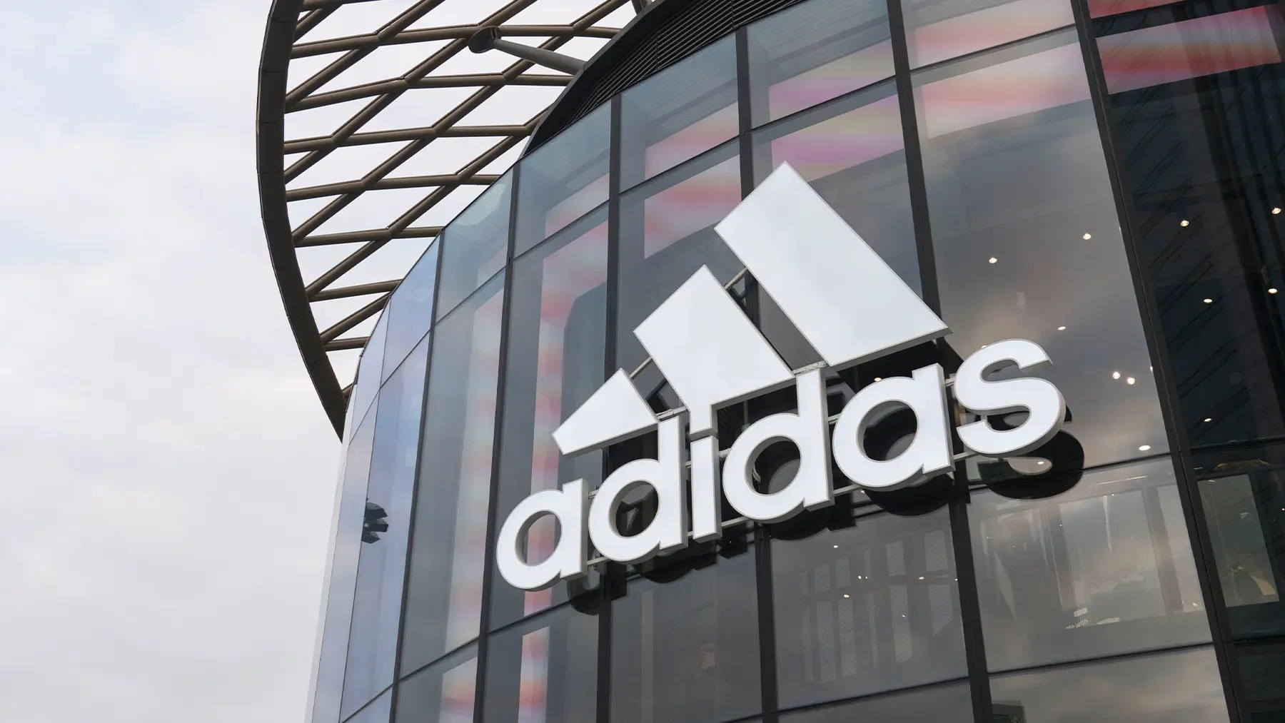 Adidas storefront with large logo on the building.