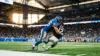 Detroit Lions linebacker making tackle at Ford Field in dramatic stadium lighting
