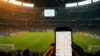 World Cup stadium scene with betting slip on smartphone during tense match moment
