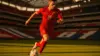 Turkish soccer player attacking with ball at modern stadium during World Cup 2026 match