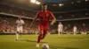 Belgium player attacking during World Cup match in packed stadium with dramatic lighting