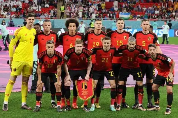 Belgium national football team in red jerseys posing for a team photo.