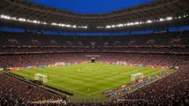 Packed World Cup stadium under floodlights during evening match with vibrant crowd and illuminated pitch