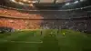 Packed World Cup soccer stadium during match with teams on field under dramatic lighting