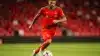 Morocco soccer player dribbling in red jersey during international match action shot
